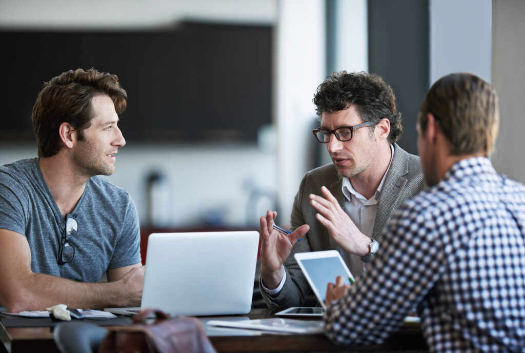 Three men in thought during a meeting